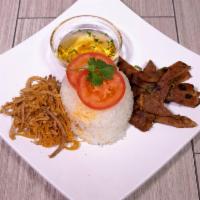 42. Grilled Mignon Lemongrass Beef · Dished up with white rice, slices of cucumbers and tomatoes along with pickled radishes. Ser...