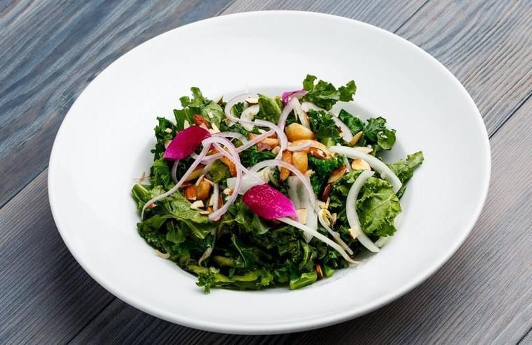 Kale Salad · Sauteed kale, onions, bean sprouts, soy sauce, roasted garlic and almonds.