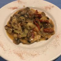 Pollo Contadino · Chicken breast sauteed with garlic, sun-dried tomatoes, artichoke hearts and mushrooms in a ...