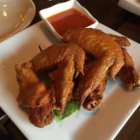 A9. Chicken Wings · Fried chicken wings served with Sriracha sauce. Extra dipping sauce will be an +$1