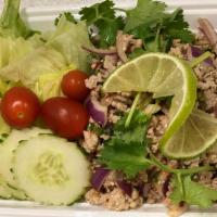Y5. Larb Pork · Ground pork mixed with peanuts, red onion, lime juice and Thai herbs. Hot and spicy.