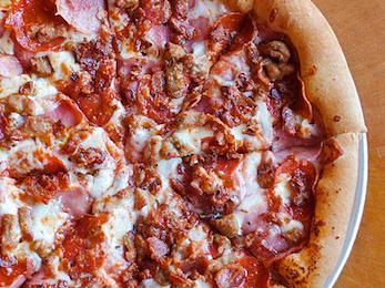 Meateater Pizza · Mozzarella, smoked ham, pepperoni, Italian sausage, crispy bacon and smoked provolone oregano.