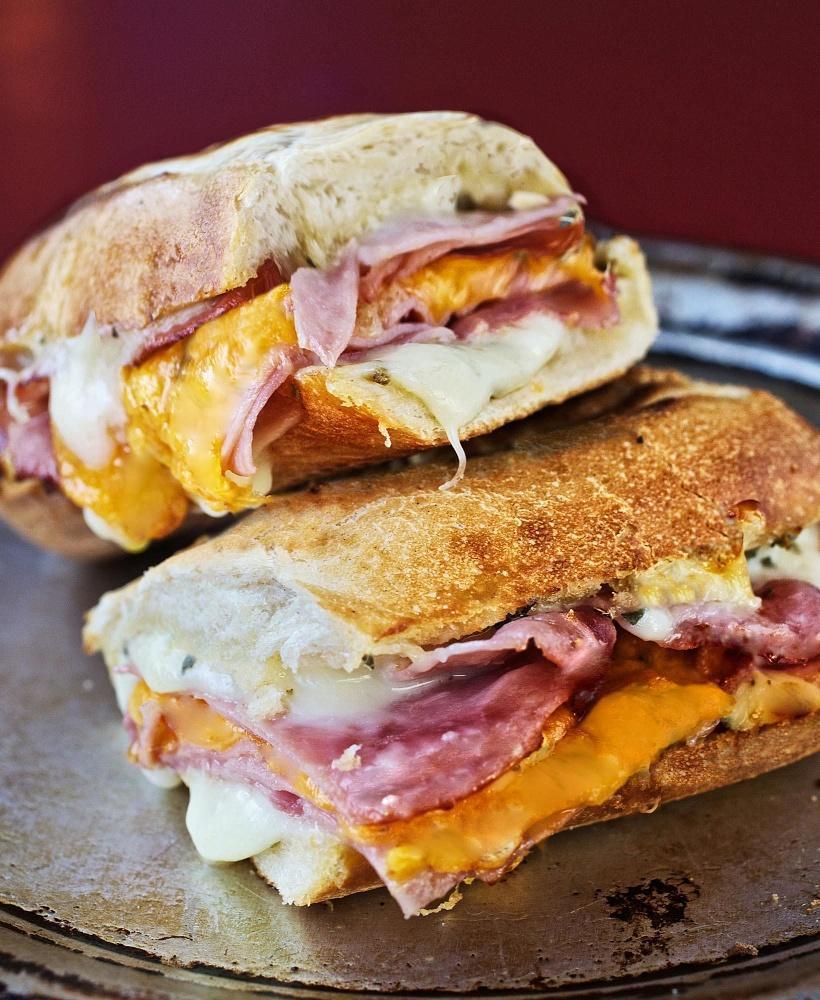Ham and Cheese Sandwich · Smoked ham layered with white American and cheddar cheese. Served toasted on a Tuscan baguette.