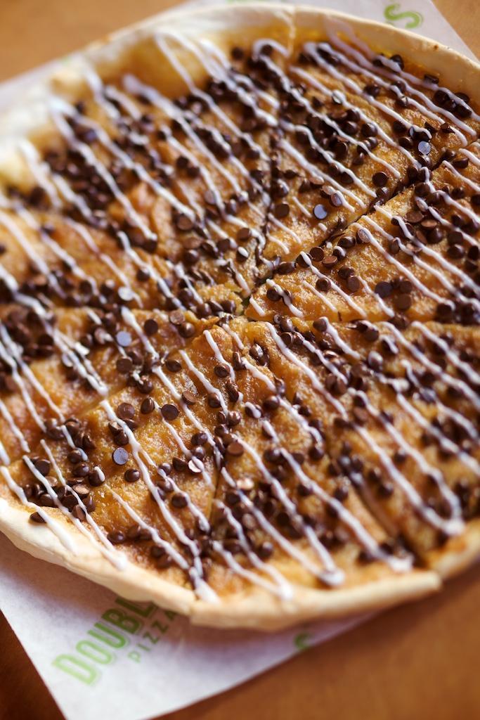 Chocolate Chip Pizza · Crispy thin crust and cookie dough topped with hot and melty chocolate chips and drizzled with icing.