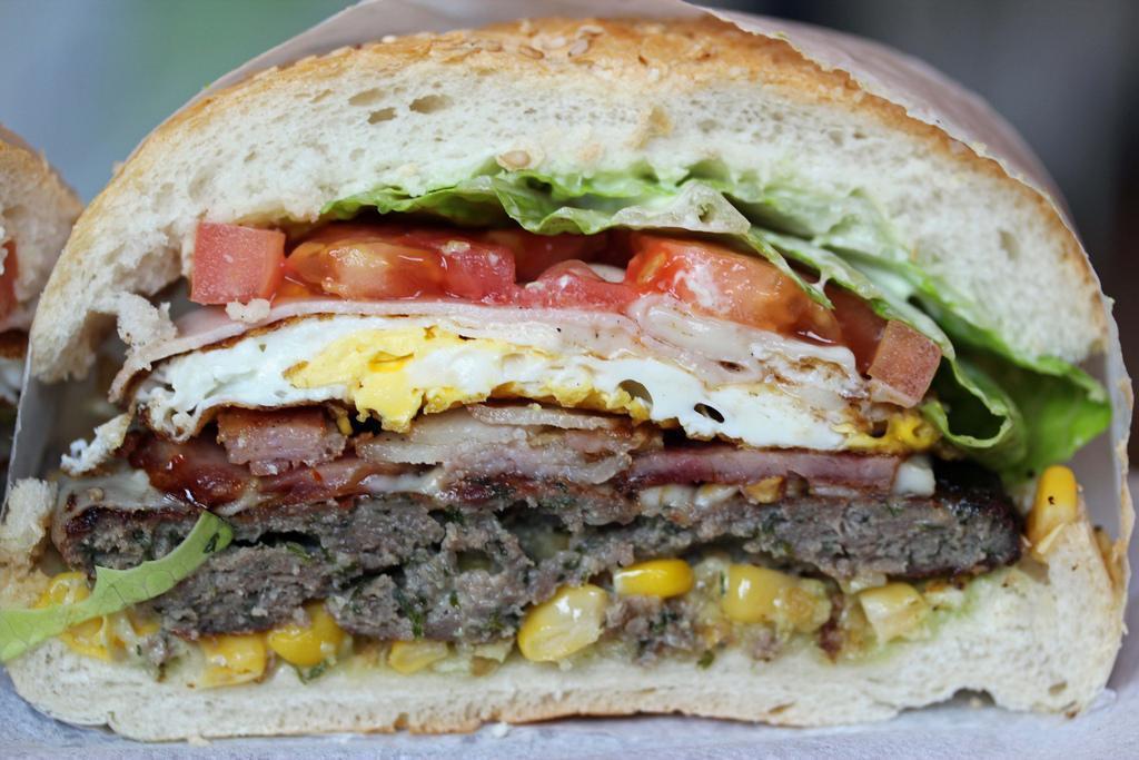 BRAZILIAN MEGA BURGER - ANGUS BEEF (BRAZILIAN X-TUDO) · ANGUS BURGER MEAT, LETTUCE, TOMATO, ONIONS, CHEESE, HAM, BACON AND FRIED EGG TOPPED WITH HOME MADE MAYO SAUCE (OUR DELICIOUS GREEN SAUCE)