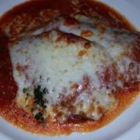 Eggplant Parmigiana · Breaded eggplant, baked with tomato sauce and mozzarella. Served with potatoes and vegetables.