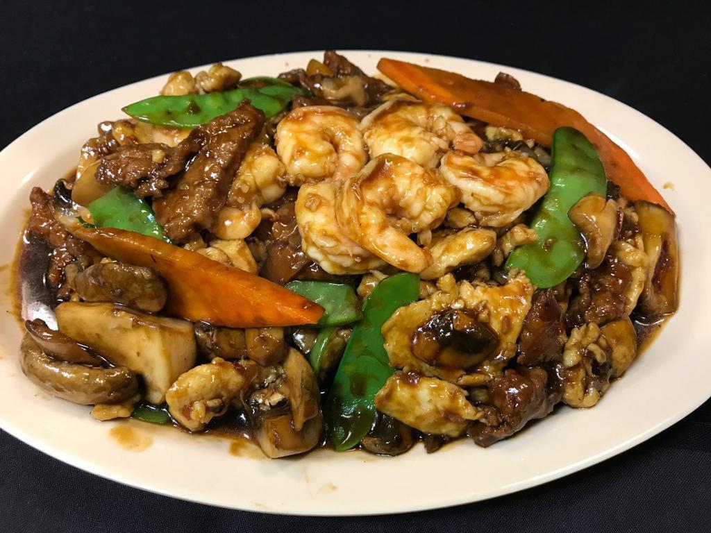 Triple Crown · Combination of large shrimp, white meat chicken and sliced flank steak, sauteed with fresh snow peas, carrots and mushrooms in chef's special spicy garlic sauce. Served with steamed or fried rice.