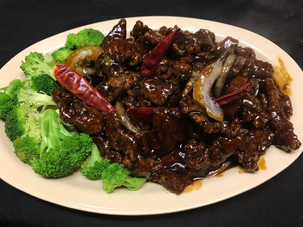 Crispy Beef in Mandarin Style · An all time favorite dish. Thinly sliced flank steak seasoned and coated with lotus flour, deep fried until crispy brown and sauteed with broccoli and onions in house special sauce. Served with steamed or fried rice.