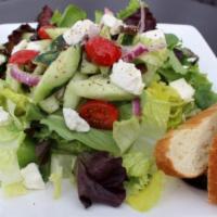 Greek Salad · Romaine lettuce, cherry tomatoes, red onions, cucumbers, kalamata olives, and feta cheese.