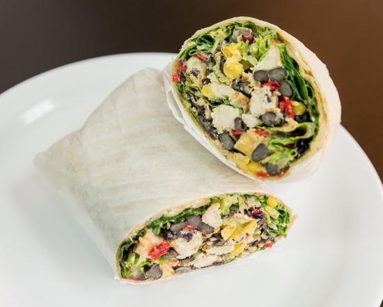 Southwest Chicken Wrap · Grilled chicken, corn, black beans, cheddar cheese, greens, Southwest dressing and tortilla strips.