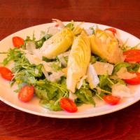 Arugula Salad · Cherry tomatoes, Grana Padano, artichoke hearts and lemon vinaigrette. Gluten free.
