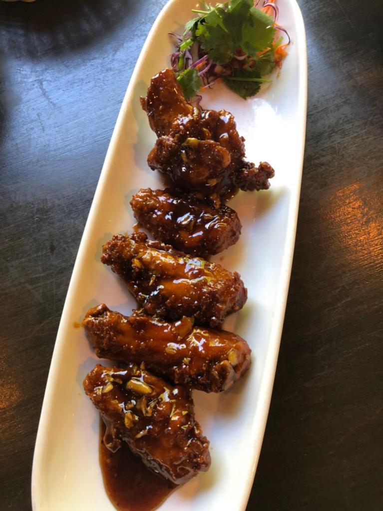 A11. GTB Chicken Wings · 5 pieces. Breaded fried wings tossed with Thai style basil garlic sauce.