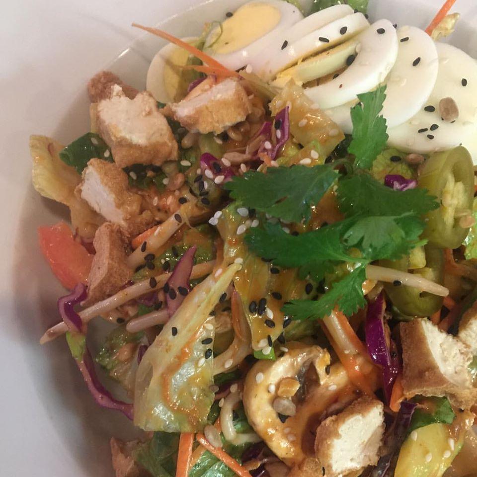 S23. Gin Thai Salad · Lettuce, bean sprouts, tomatoes, carrots, cabbages, mushrooms, ground peanuts, sesame seeds, pumpkin seeds, sunflower seeds, cucumbers, hard-boiled egg topped with peanut sauce dressing and jalapenos.