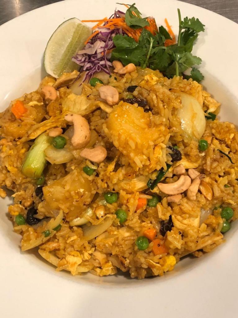 D94. Pineapple Fried Rice · Comes with choice of meat or tofu and fried rice with eggs, pineapples, onions, raisins, peas and carrots, cashew nuts and curry powder in special sauce.