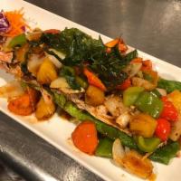 Pla Tod Rad Prik · Fried whole tilapia with sauteed onions, bell peppers, tomatoes, pineapples and basil topped...