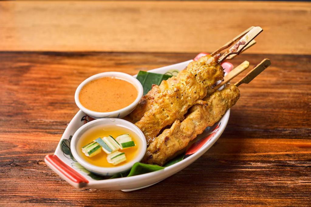 Chicken Satay · Thai marinated chicken satay served with peanut sauce.