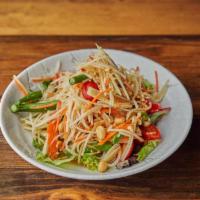Som Tum Thai Salad 🌶 · Spiced papaya salad with long bean, tomato, carrot and peanut.