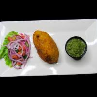 Papa Rellena · Stuffed potato with seasoned beef, onions, tomatoes and a touch of raisins and olives, serve...