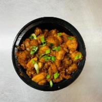Chicken Manchurian · Deep fried spiced chicken tossed with soya sauce based gravy, cooked to perfection.
