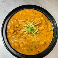 Punjabi Chana Masala · Traditional chickpeas dish cooked in ginger, infused onion and tomato sauce.