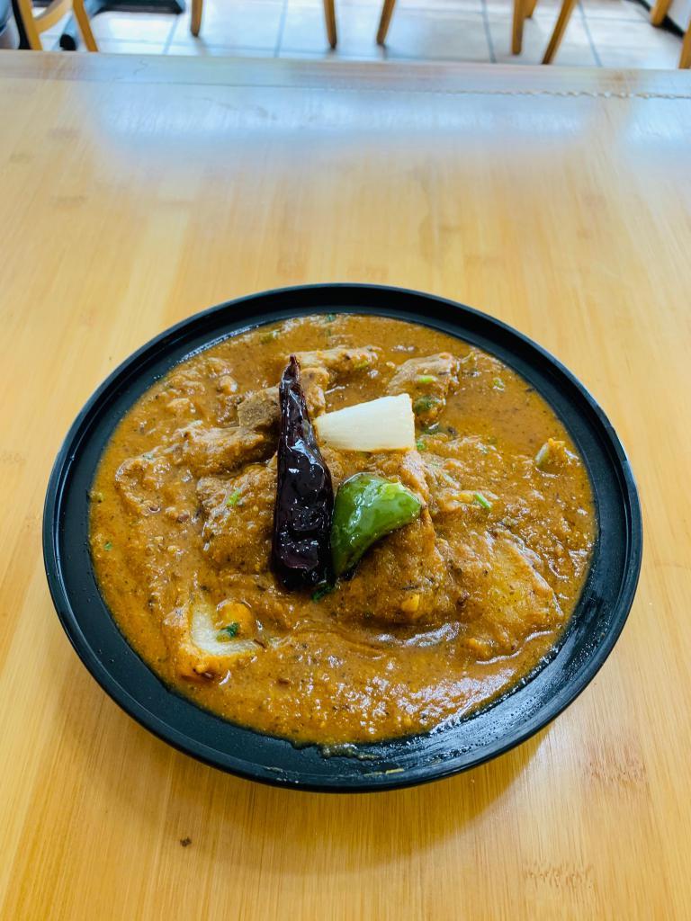 Kadai Chicken · Chicken, cooked with bell peppers, onions and tomatoes with a touch of cream and onion gravy.