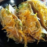 Crunchy Shredded Tacos Chicken · Crunchy tacos with your choice of shredded beef or chicken, topped with lettuce, cabbage, ch...