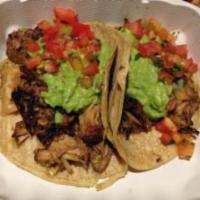 Carnitas Taco · Roasted and shredded pulled pork served on corn tortilla topped with salsa fresca, fresh gua...