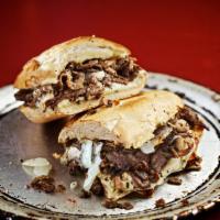 Philly Cheesesteak Sandwich · Seasoned grilled steak, onions, and mushrooms with white American and smoked provolone chees...