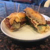 Zesty Breakfast Sandwich · Two over medium eggs together with pepper jack cheese, tomatoes, spinach and bacon and place...