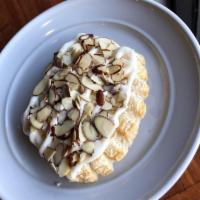 Bear Claws · 2 mini bear claws topped with delicious cream cheese icing drizzle and sliced almonds.