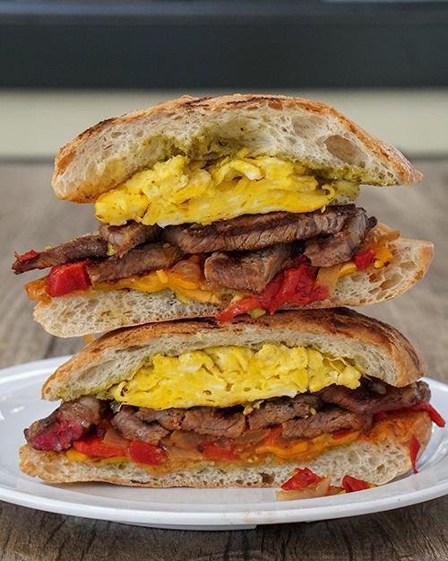 Steak and Egg Breakfast Sandwich · House roasted Harris ranch top sirloin, egg, grilled onions, roasted
bell peppers, sharp cheddar cheese, roasted poblano aioli and ciabatta.