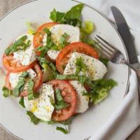 Caprese Salad · Sliced tomatoes and sliced fresh mozzarella seasoned with salt, pepper, oregano, basil and a...