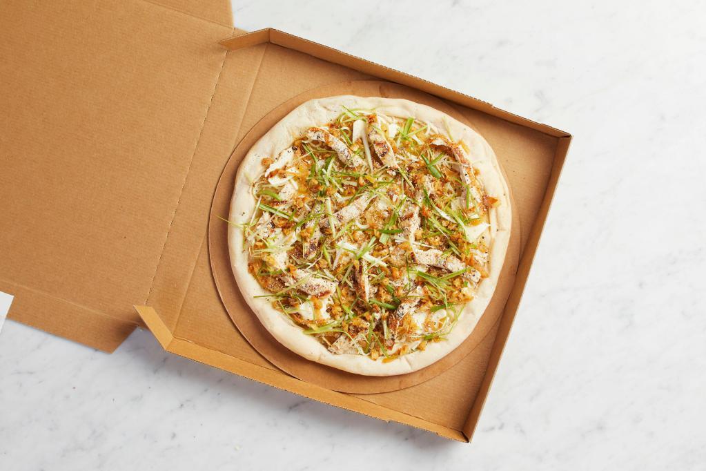 Take and Bake Roasted Garlic Chicken Pizza · READY TO BAKE - Sweet caramelized onions, fresh mozzarella, Parmesan, slivered scallions and cracked black pepper.