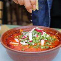 Pozole · Hominy, cilantro, onion, jalapeno, lime, and tostadas. Served with a choice of chicken or po...
