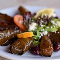 Dolmas · Grape leaves stuffed with rice, tomato, onion, and cooked in olive oil and lemon juice.