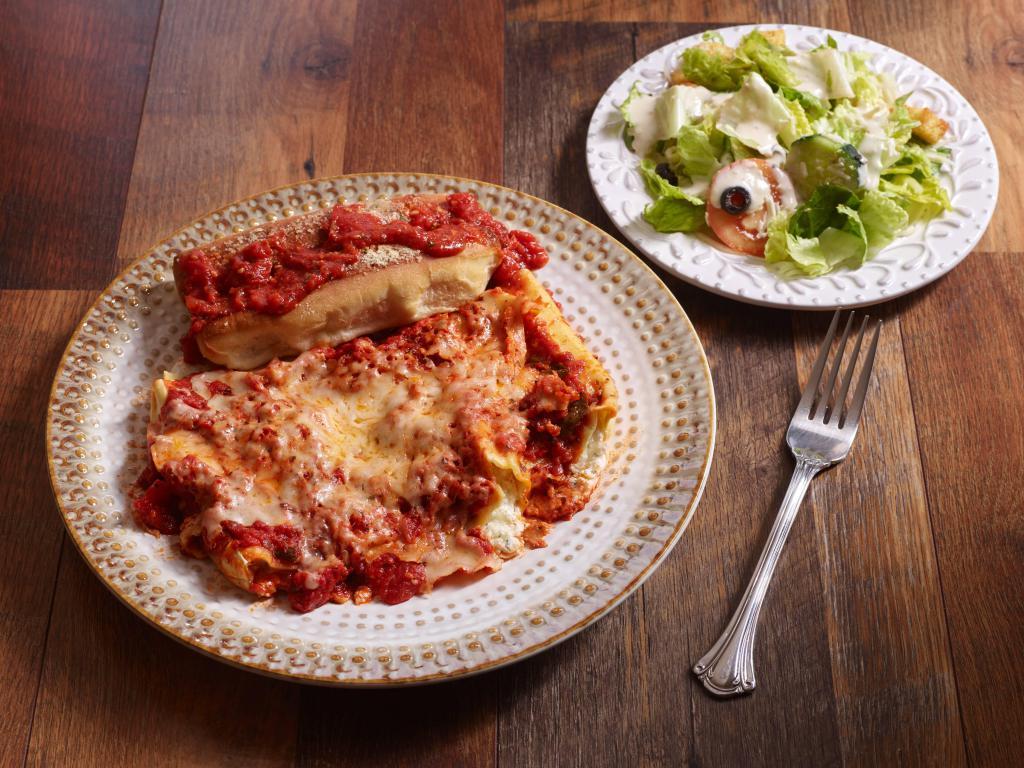 Our Famous Cheese Manicotti · Pasta tubes filled with ricotta and topped with marinara sauce and mozzarella.