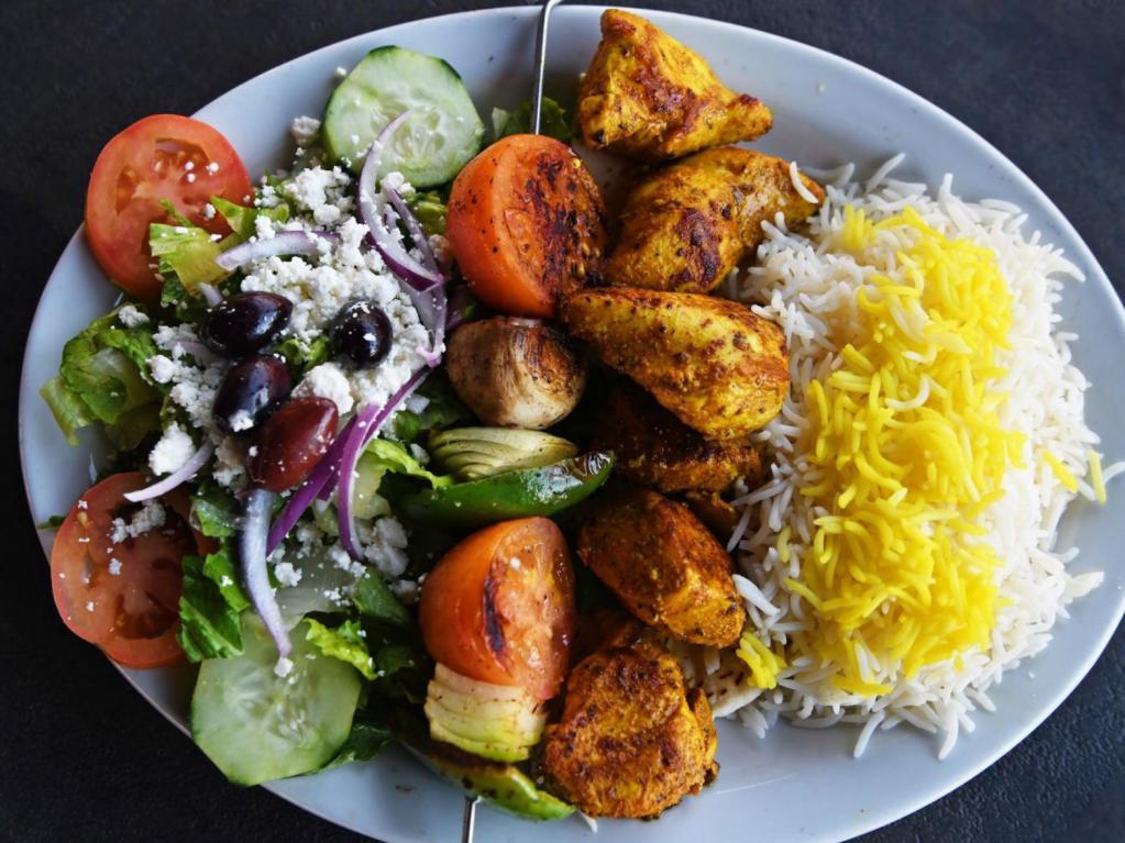 Shish Kabob · Herb marinated kabobs grilled to perfection and served with basmati rice, a vegetable skewer and a Greek salad. Gluten free.