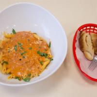 Penne alla Vodka · Creamy pink sauce made with diced prosciutto and onions. Served with homemade dinner rolls.