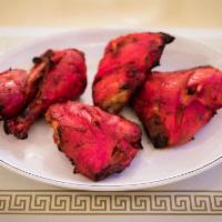 Chicken Tandoori with Bone Specialty · Chicken marinated in yogurt and mild spices with its own natural juices, roasted in our tand...