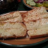 Cheese Bread · Garlic bread topped with mozzarella and Parmesan cheeses. Served with marinara sauce.