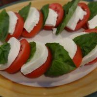 Caprese Salad · Fresh mozzarella, tomatoes and basil topped with our homemade Italian dressing.