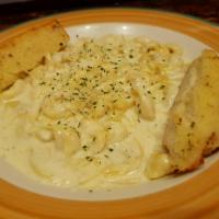 Tortellini a la Creme · Cheese filled tortellini in garlic sauce. Served with garlic bread and a side.