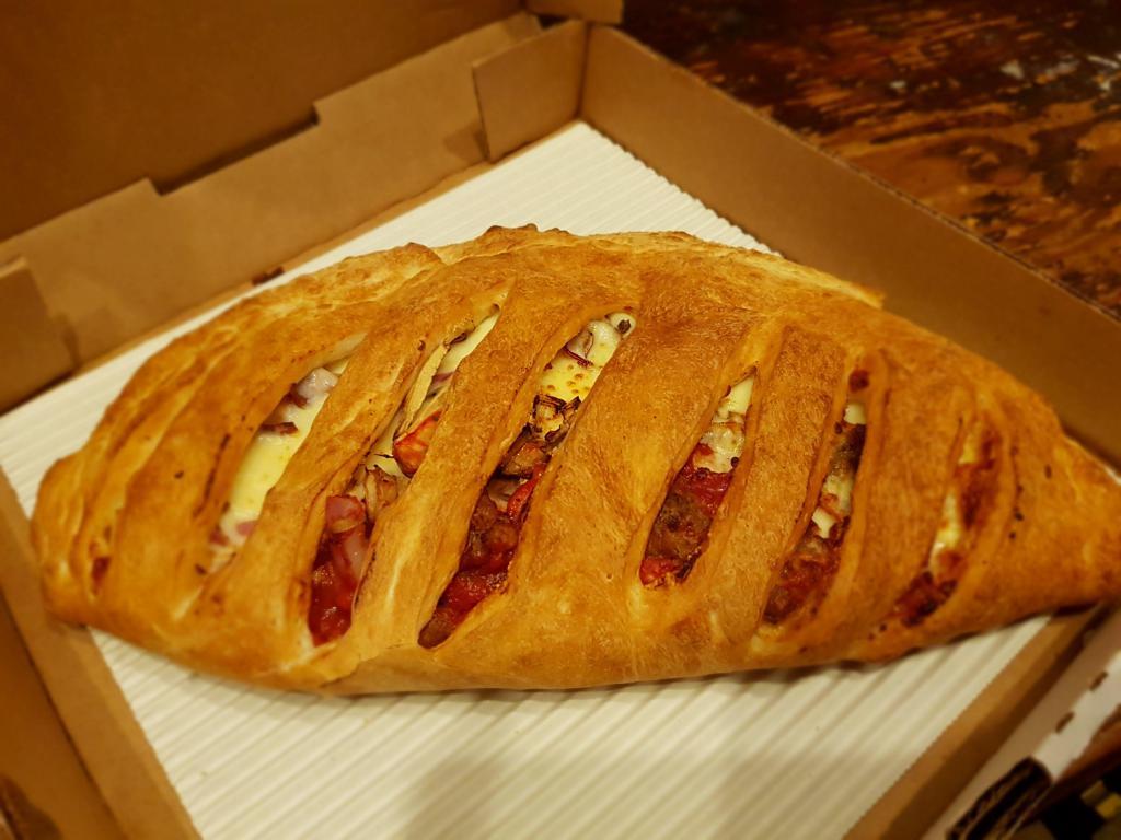 House Calzone · Pepperoni, Canadian bacon, onions and mushrooms. Served with mozzarella cheese and romios homemade pizza sauce.