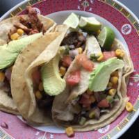 Tacos · 3 corn tortillas with short ribs, chicken or bulgogi. Served with pico de gallo and avocado.