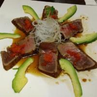 Tuna Tataki · Slightly seared and peppered tuna sliced and served with ponzu sauce. Hot and spicy.
