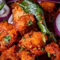 Persis Chicken 65 · Chicken marinated in spiced corn flour batter, fried and tossed with yogurt and spices.