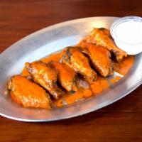 Traditional Wings · Cooked wing of a chicken coated in sauce or seasoning.