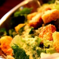 Caesar Salad · Romaine lettuce, shaved Parmesan, and seasoned croutons.
