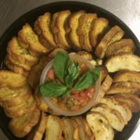 Bruschetta · 6 pieces. Toasted seasoned crostini served with tomato, garlic, olive oil and basil.