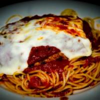 Chicken Parmigiana · Chicken cutlet breaded and sauteed in tomato sauce with mozzarella cheese served spaghetti o...